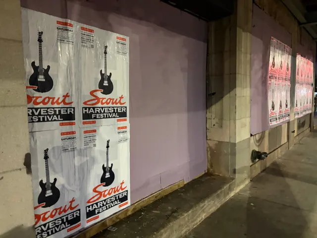 Scout Harvester wheatpaste in the white and silver colorway on lavender at West Trade Street, a red-orange cluster further down