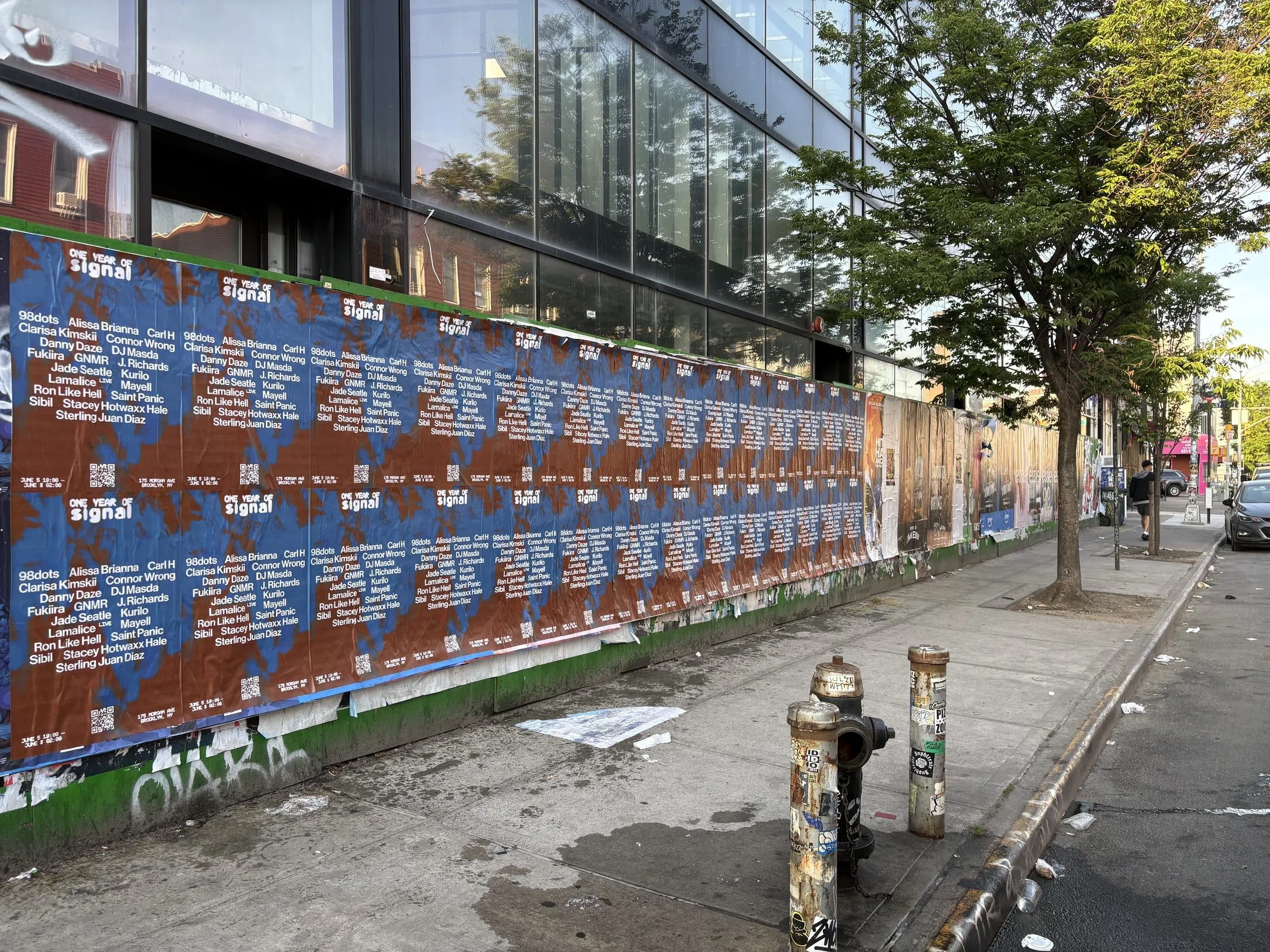 Signal anniversary posters running a long Brooklyn wall by Beyond Street Media