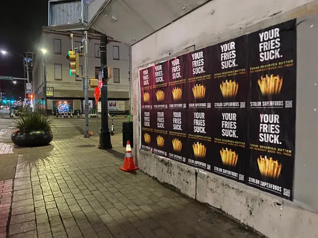 Stolon Superfoods wheatpaste posters, twelve in two rows of six, under an overhang on Congress Avenue at 5th, downtown, at night