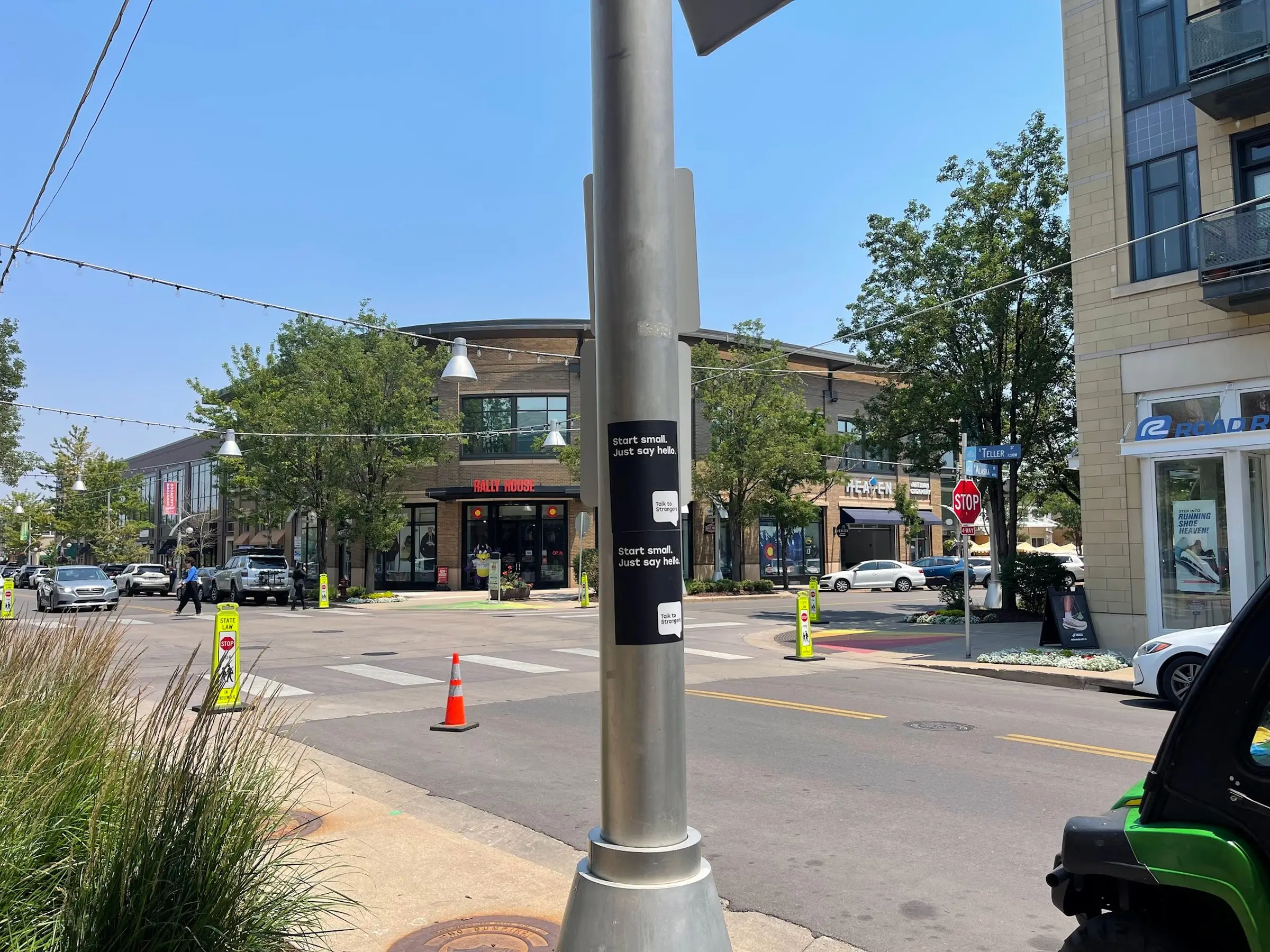 Talk to Strangers pole sticker install by Beyond Street Media at 400 S Teller St, Lakewood, Colorado — a pole sticker on a light pole in the Belmar retail district.