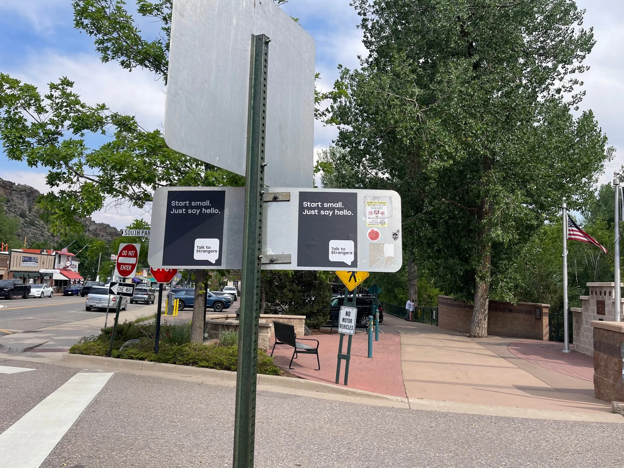 Talk to Strangers pole sticker install by Beyond Street Media at 22 S Park Ave, Morrison, Colorado — pole stickers on a street pole in a small downtown core.