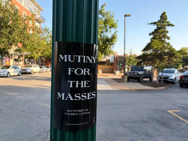 Mutiny for the Masses pole snipe on a ridged green pole at Broadway Boulevard, Westport, a Jeep parked near brick apartments at dusk