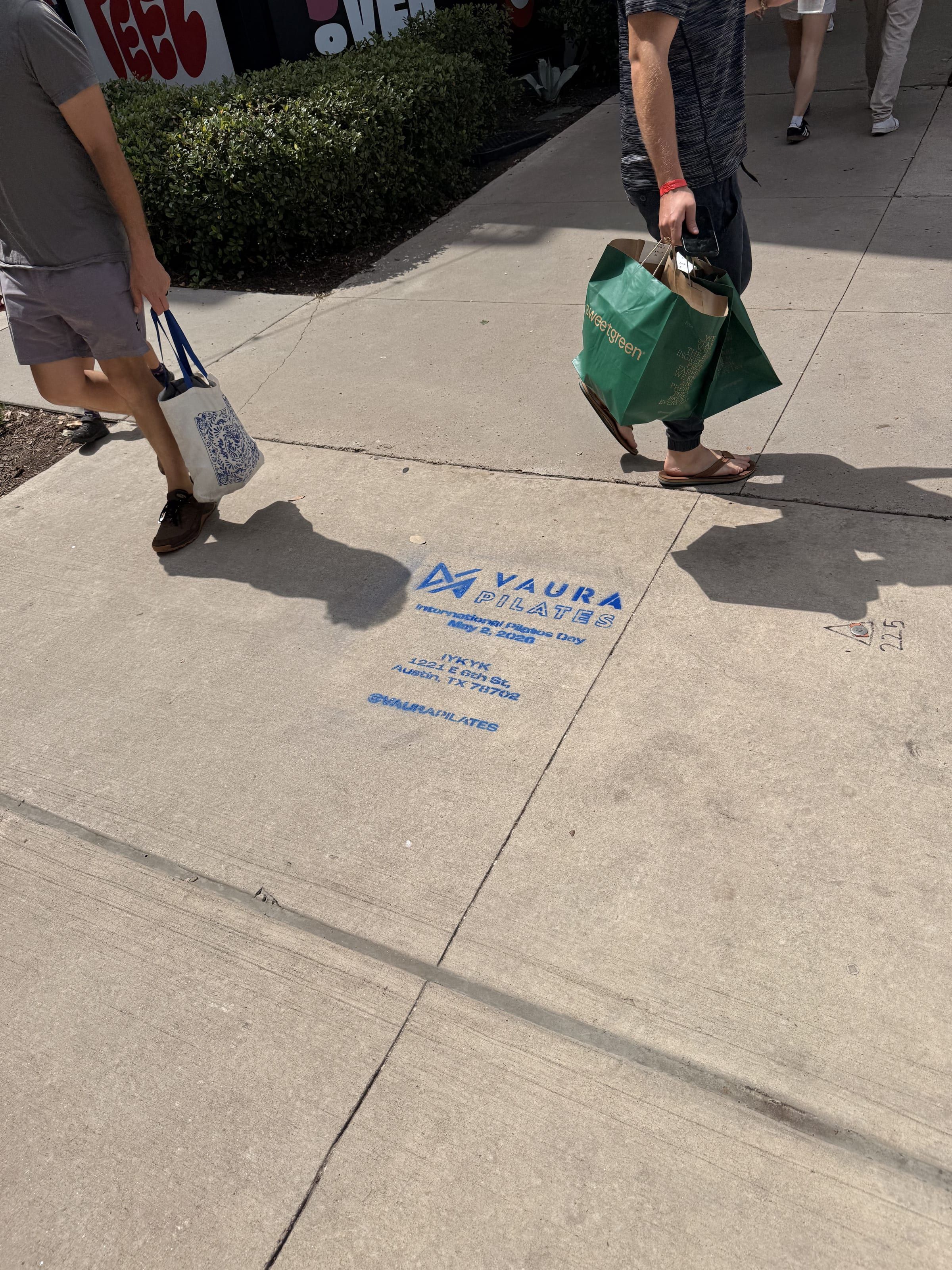VAURA Pilates blue chalk-stencil on the East 6th Street sidewalk in Austin TX, Beyond Street Media install, by Beyond Street Media