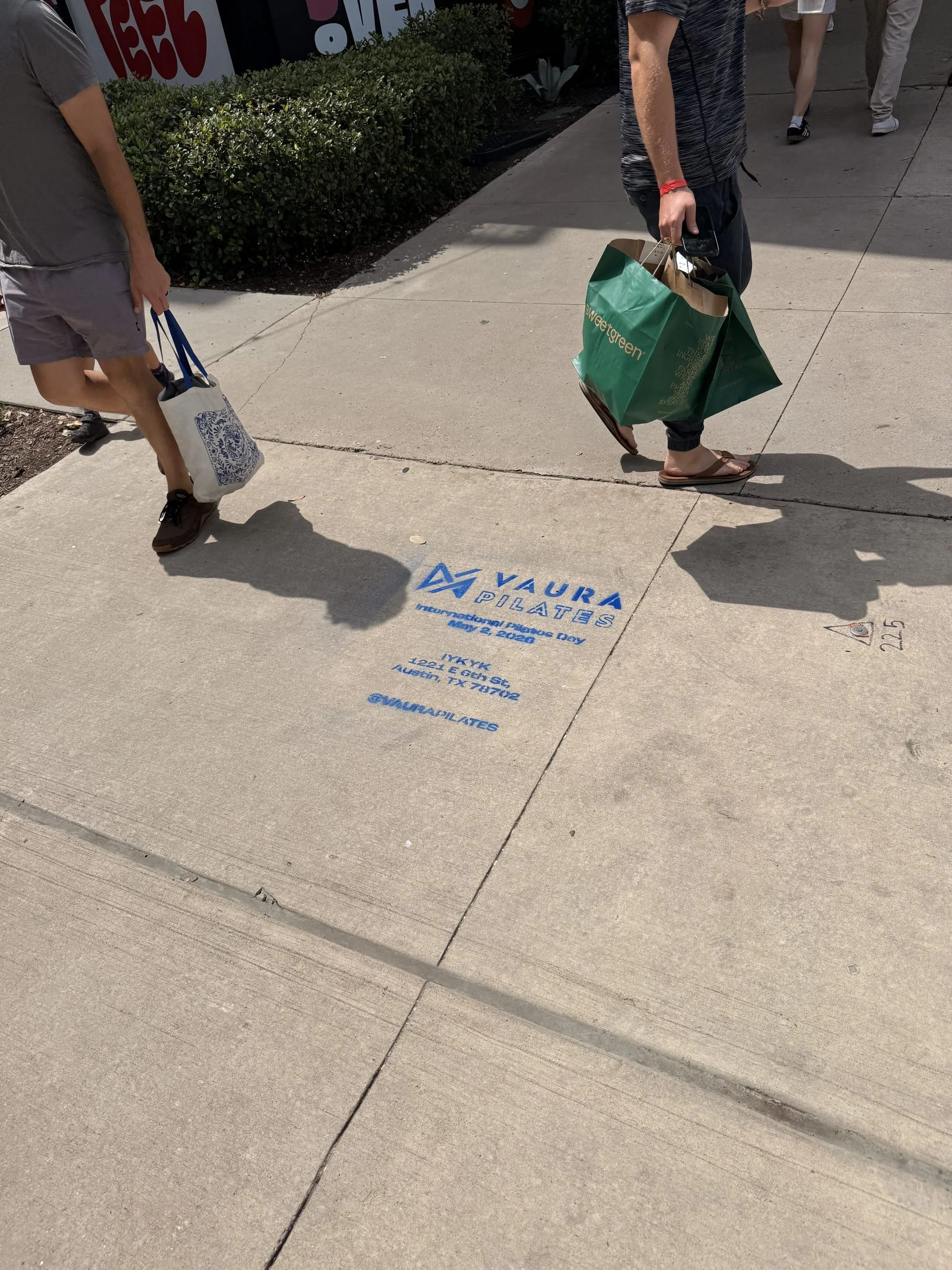 VAURA Pilates blue chalk-stencil on the East 6th Street sidewalk in Austin TX, documented street install, by Beyond Street Media