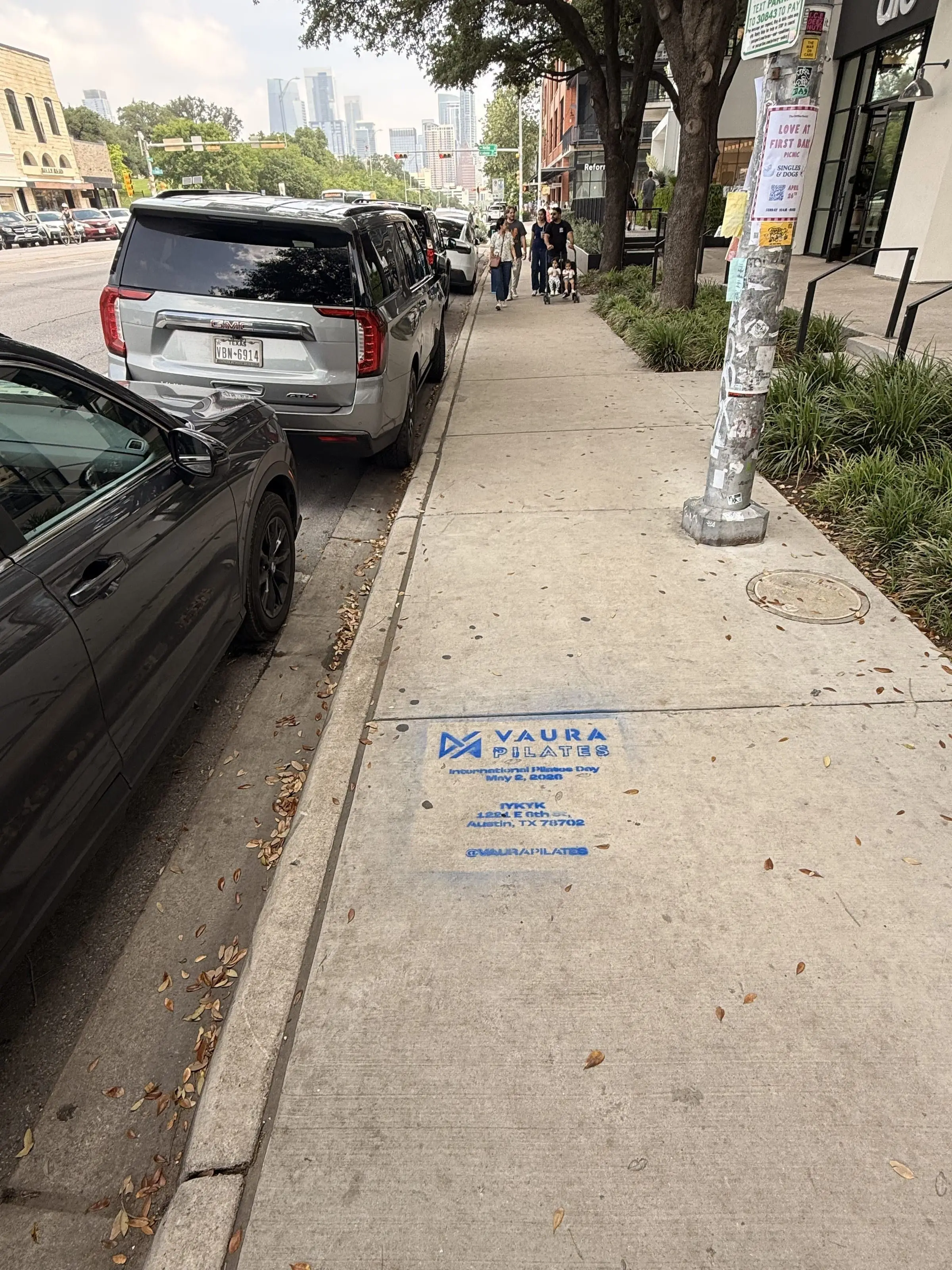 VAURA Pilates blue chalk-stencil on the East 6th Street sidewalk in Austin TX, documented street install, by Beyond Street Media