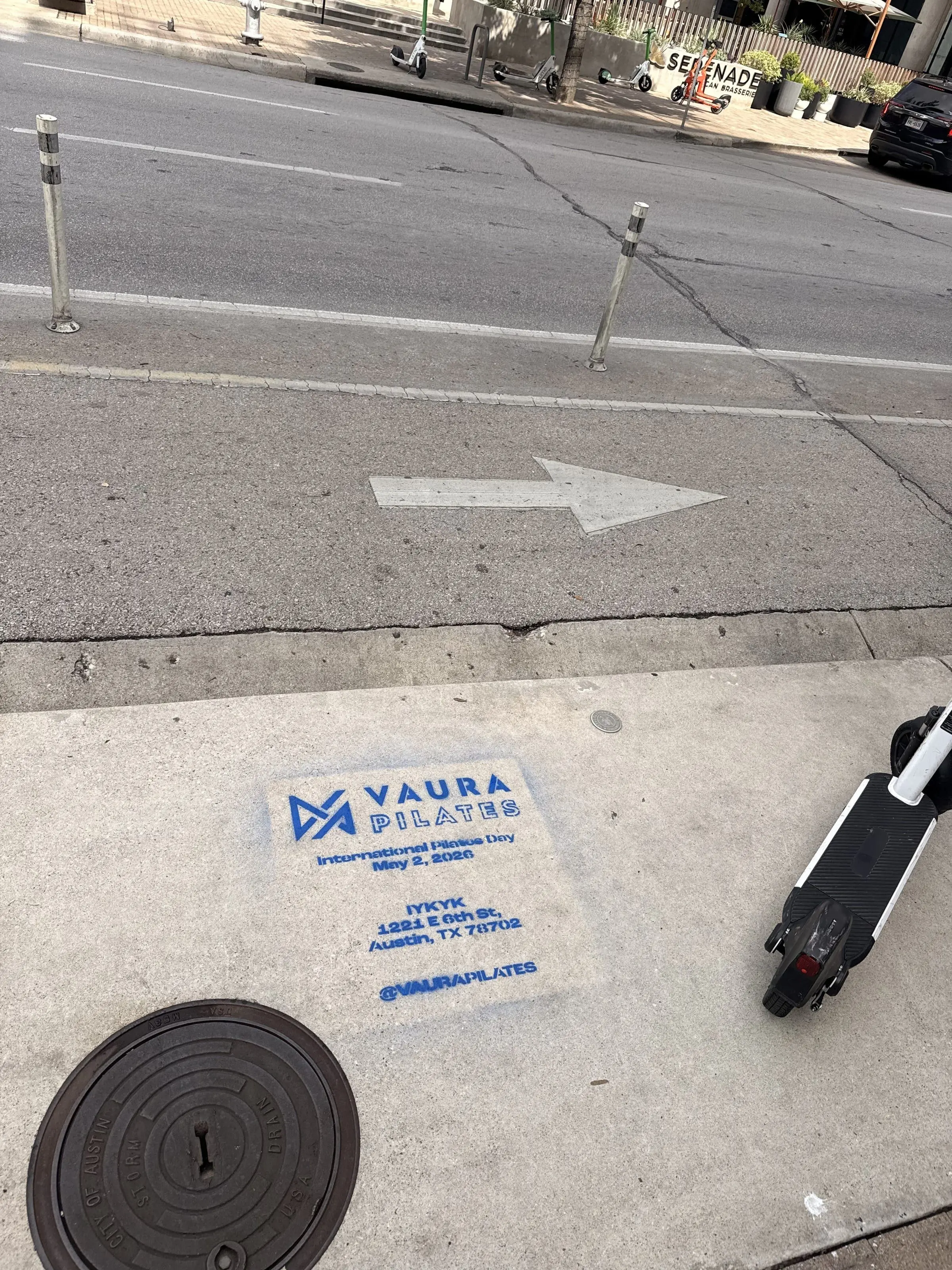 VAURA Pilates blue chalk-stencil on the East 6th Street sidewalk in Austin TX, documented street install, by Beyond Street Media