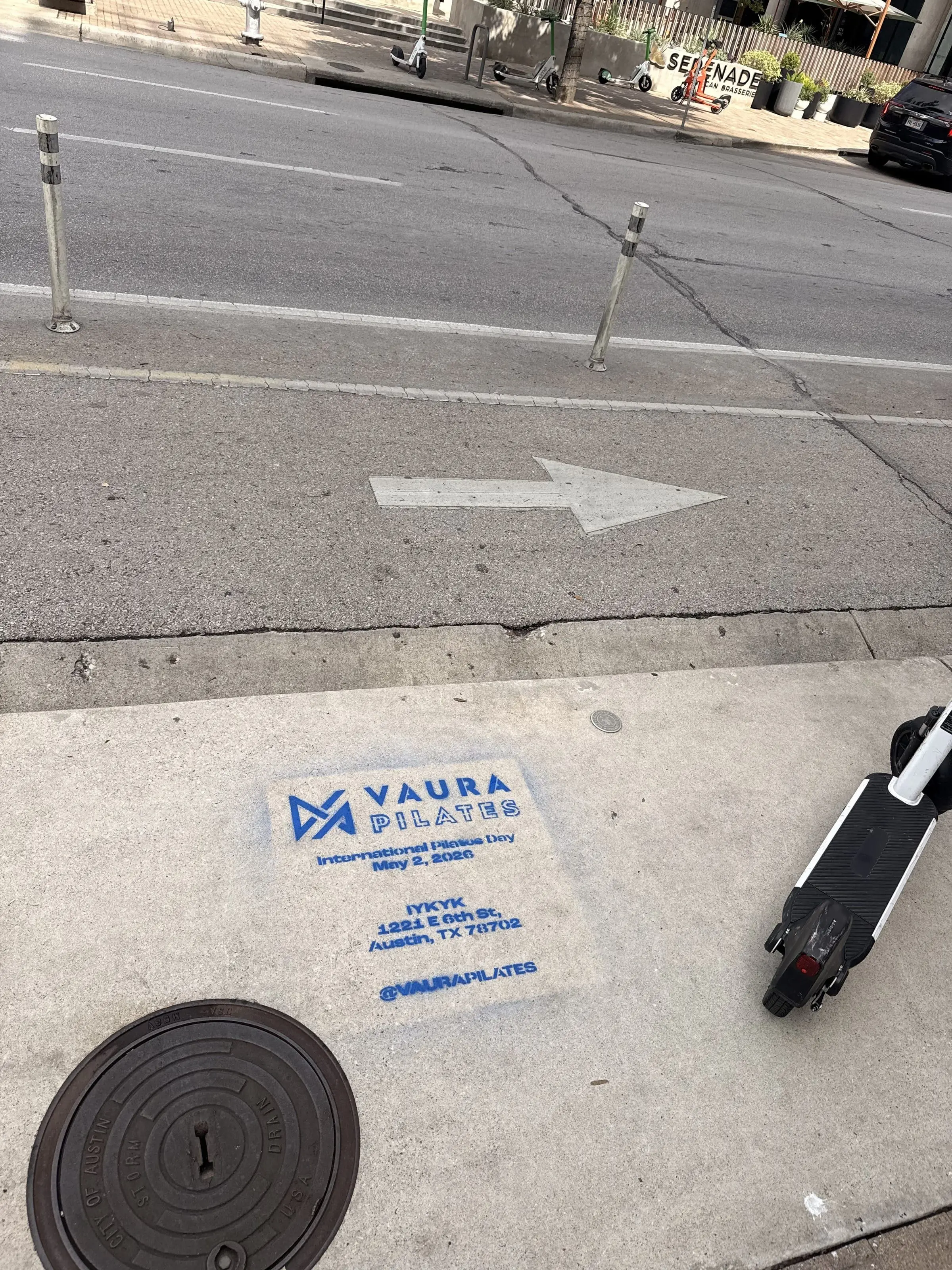 VAURA Pilates blue chalk-stencil on the East 6th Street sidewalk in Austin TX, documented street install, by Beyond Street Media