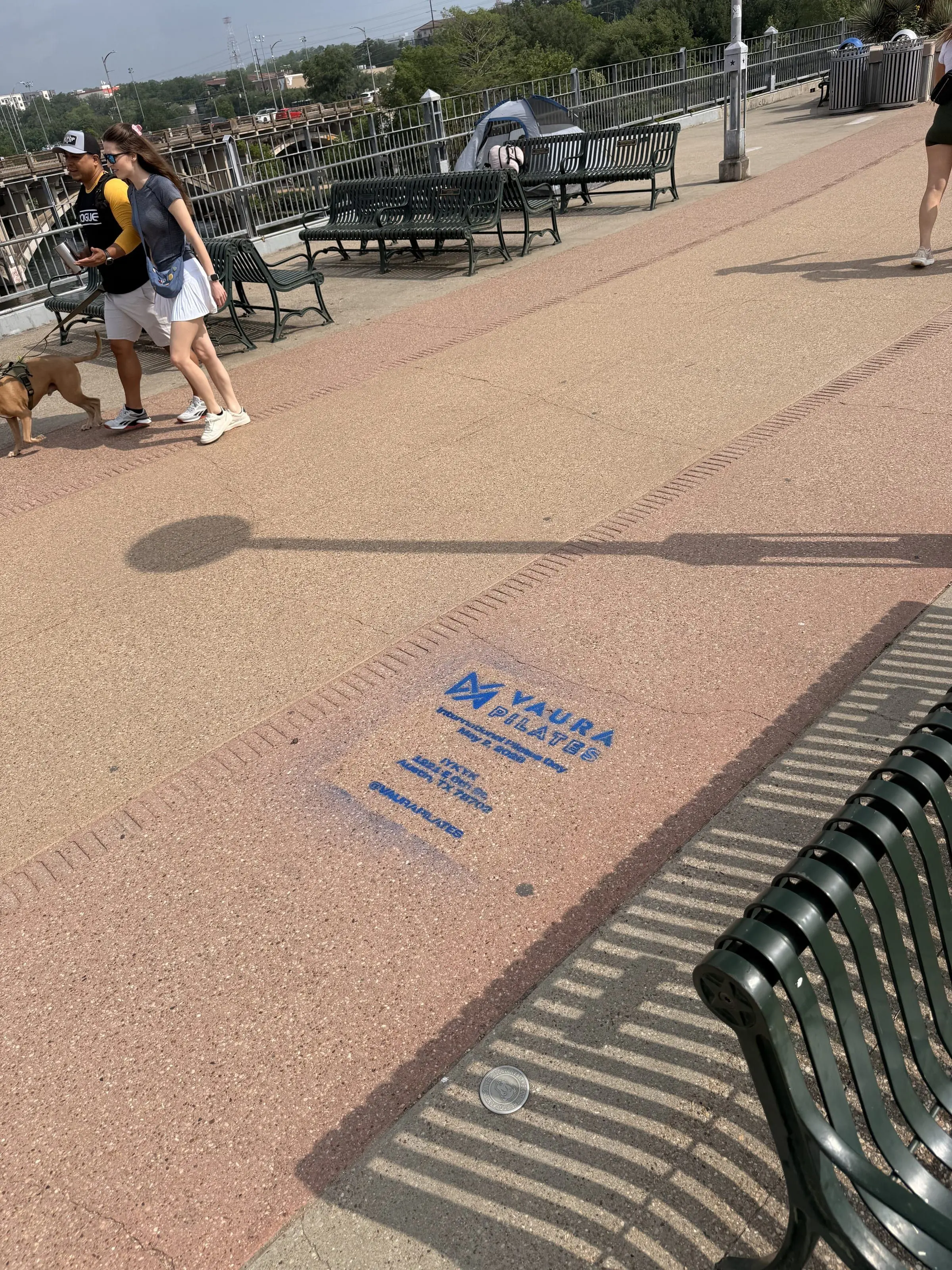 VAURA Pilates blue chalk-stencil on the East 6th Street sidewalk in Austin TX, documented street install, by Beyond Street Media