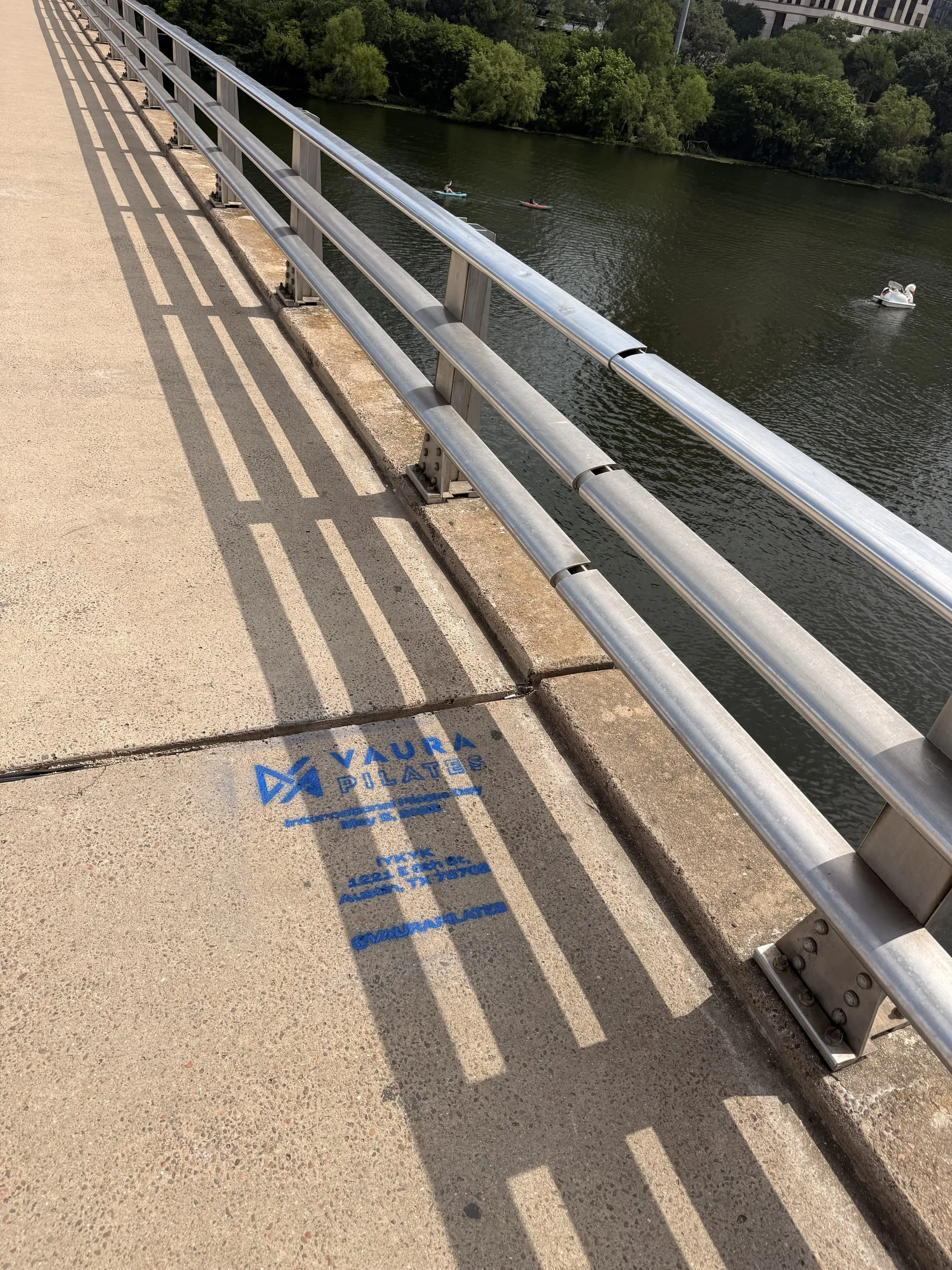 VAURA Pilates blue chalk-stencil on the East 6th Street sidewalk in Austin TX, documented street install, by Beyond Street Media