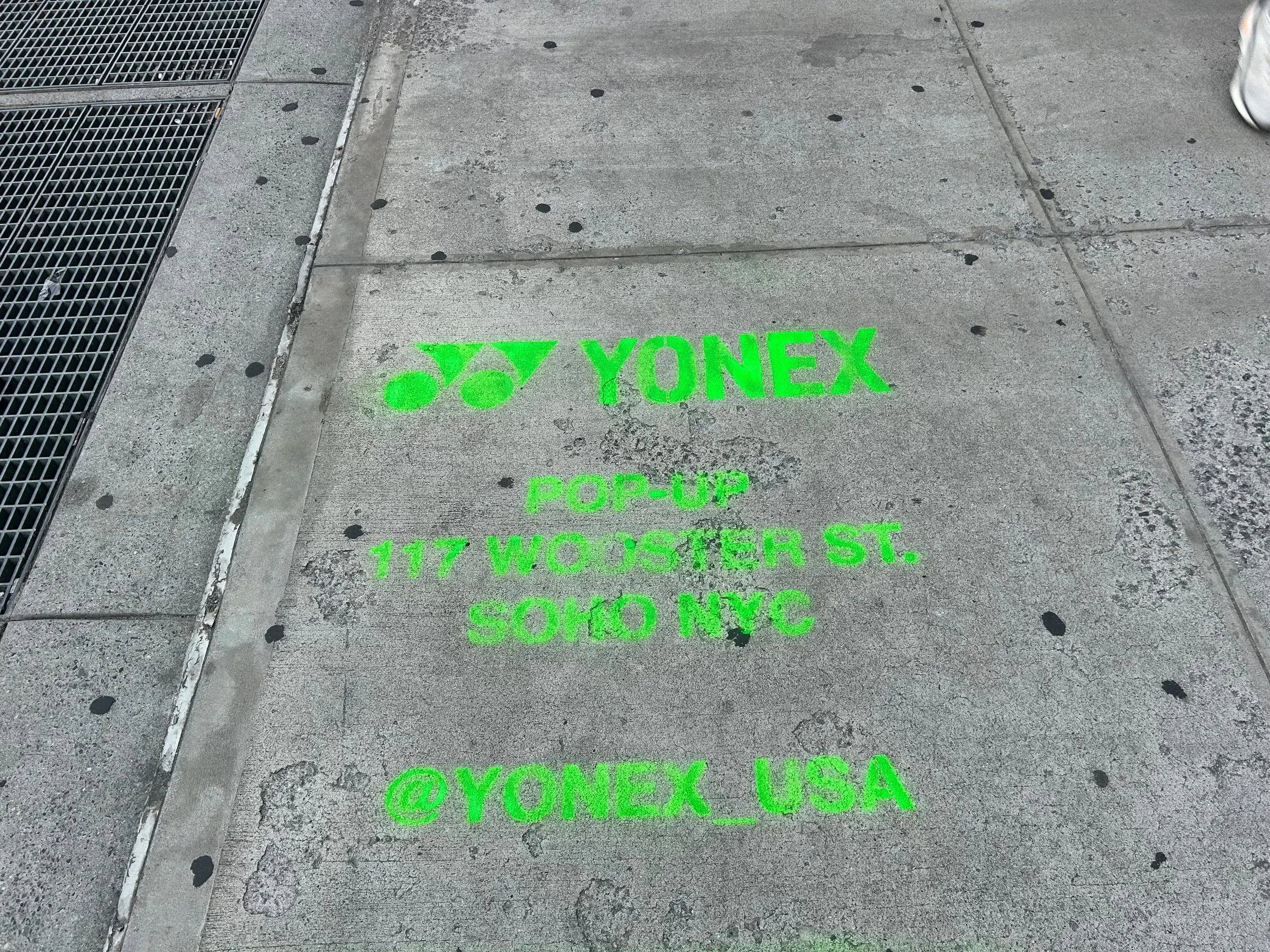 Yonex Pop-Up sidewalk stencil at 117 Wooster St, SoHo NYC - neon-green spray stencil by Beyond Street Media