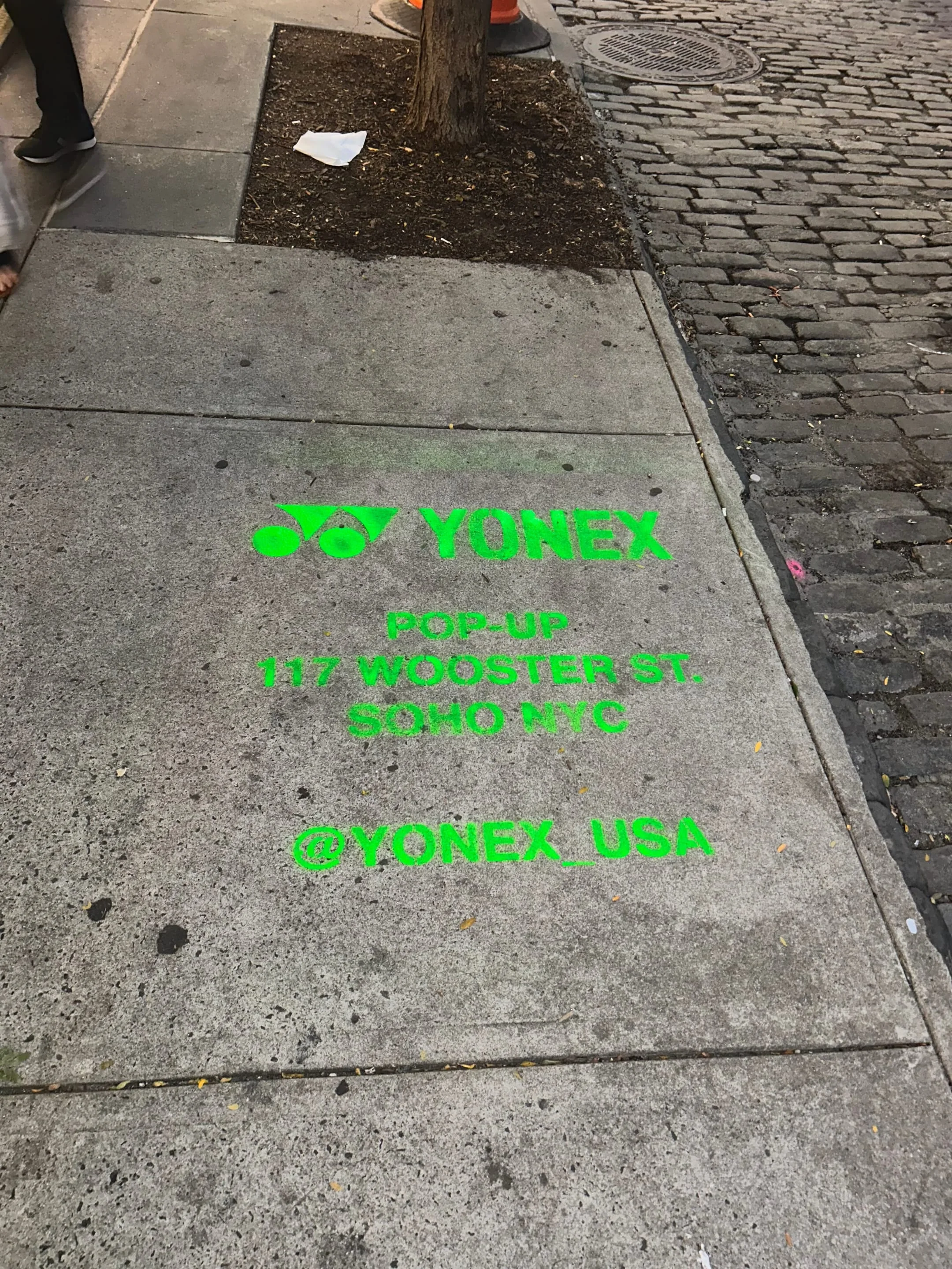 Yonex Pop-Up sidewalk stencil at 117 Wooster St, SoHo NYC - neon-green spray stencil by Beyond Street Media