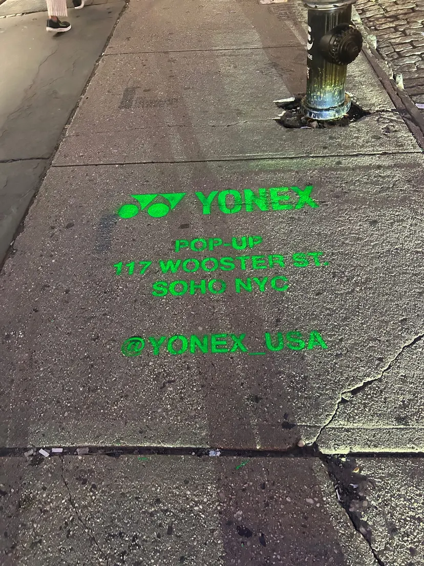 Yonex Pop-Up sidewalk stencil at 117 Wooster St, SoHo NYC - neon-green spray stencil by Beyond Street Media (photo 5 of 28).