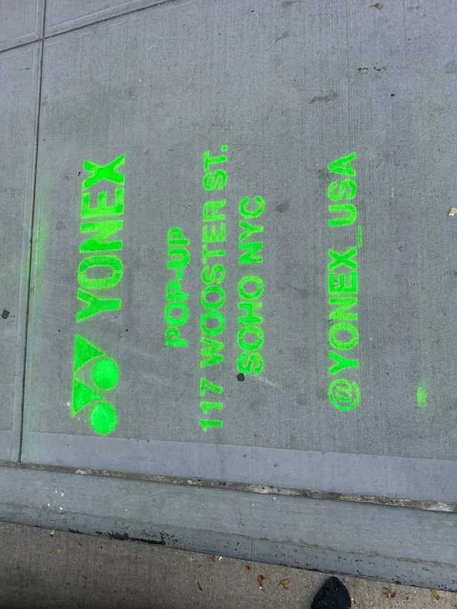 Yonex Pop-Up sidewalk stencil at 117 Wooster St, SoHo NYC - neon-green spray stencil by Beyond Street Media (photo 14 of 28).